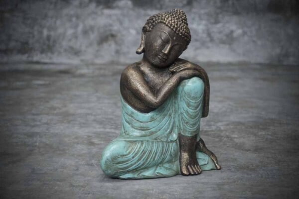 Buddha head resting on his knee