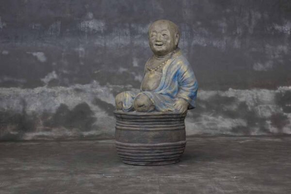 laughing little buddha sitting on bowl