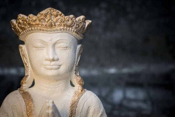 Crowned Buddha praying details white