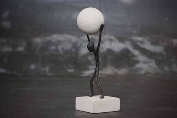 Abstract figure holding ball
